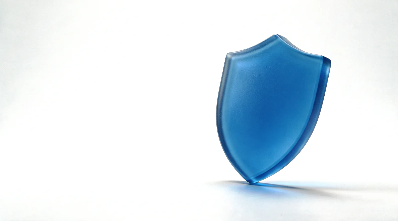 A single upright frosted blue glass shield form on a white studio ground
